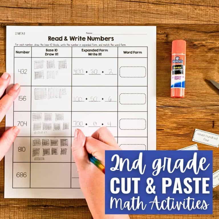 A person works on a worksheet titled Read & Write Numbers, drawing base tens and writing number words. A glue stick and pencil are nearby. The label reads, Cut & Paste Math Activities for Second Grade.