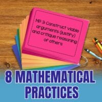 A stack of Mathematical Practices Partner and Group Discussion Cards sits on a wooden surface, with a pink card displaying "MP 3: Construct viable arguments (justify) and critique reasoning of others." Crayons are nearby.