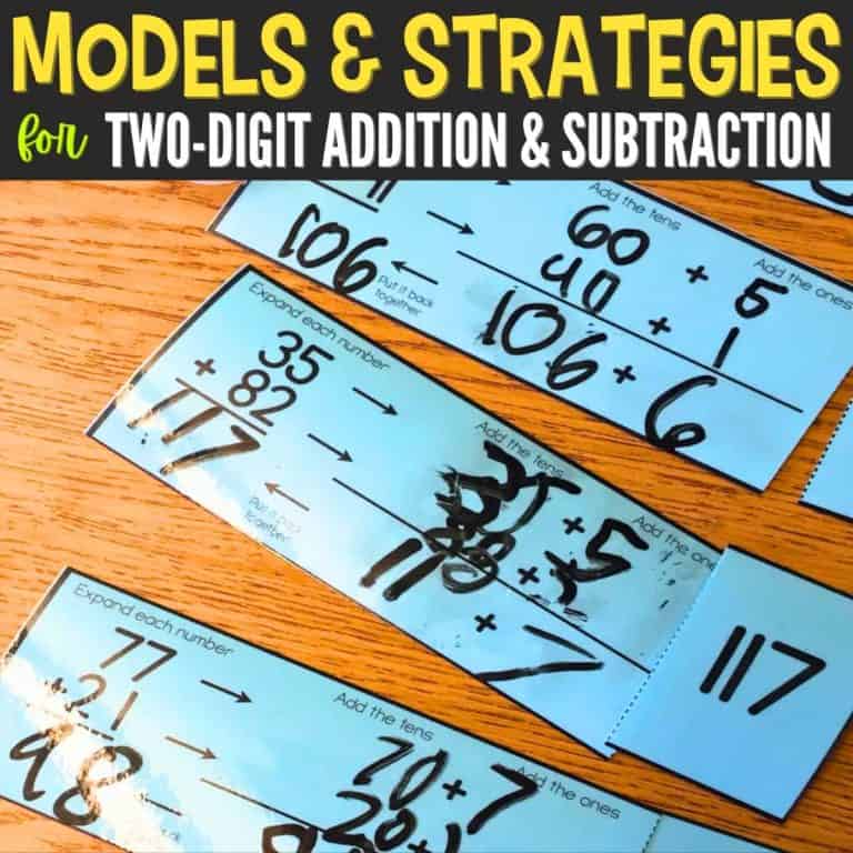 Blue math cards on a wooden table show expanded form examples for two-digit addition and subtraction strategies, with handwritten numbers. Text above reads “Models & Strategies for Two-Digit Addition & Subtraction.”.