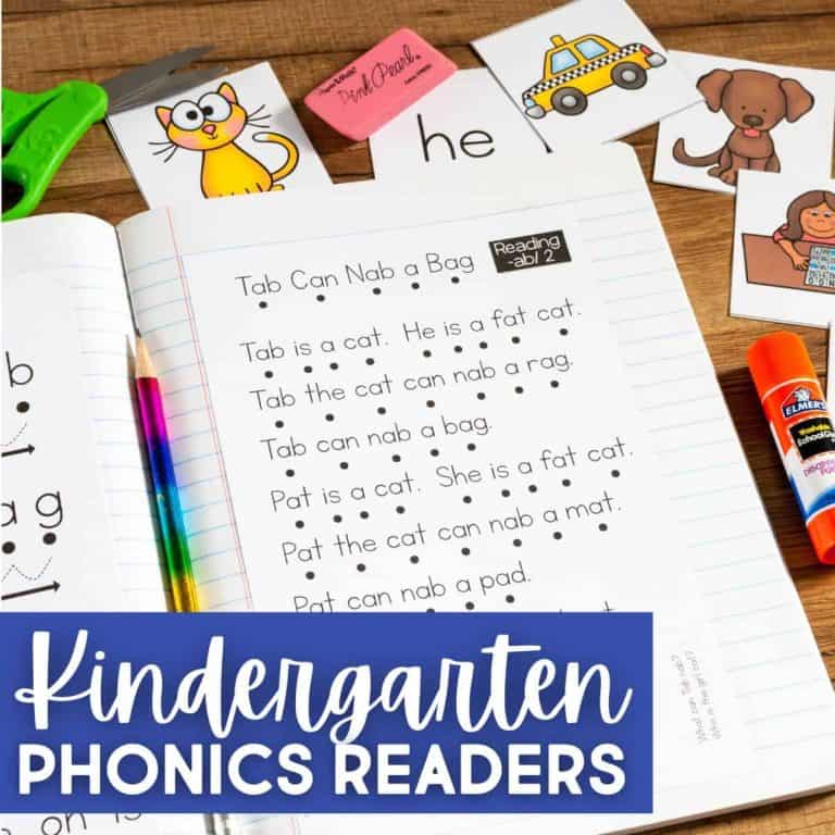 An open notebook shows simple sentences for early readers, surrounded by animal and object flashcards, scissors, a glue stick, and a pencil. Text overlay says Word Family Phonics Readers for Kindergarten.