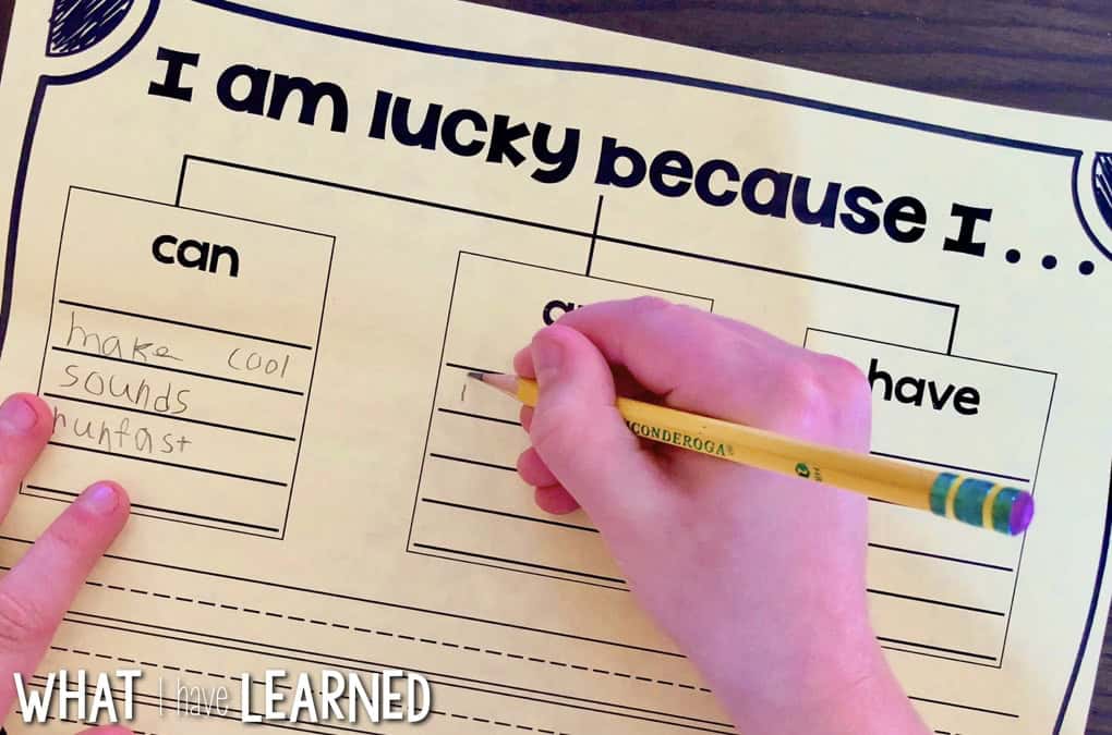 I Am Lucky St. Patrick's Day Craftivity 5 A child writes with a pencil on a St. Patrick's Day Craftivity worksheet titled I am lucky because I... Columns labeled can, are, and have include the child's answers: make cool sounds and run fast in the can column.