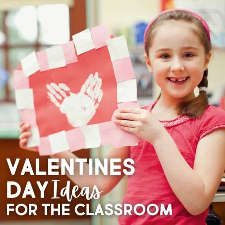 Smiling young girl in a classroom holding a handmade Valentine’s Day card with white handprints and a pink and white border. Text overlay: FREE Valentine's Day Classroom Activity Ideas.