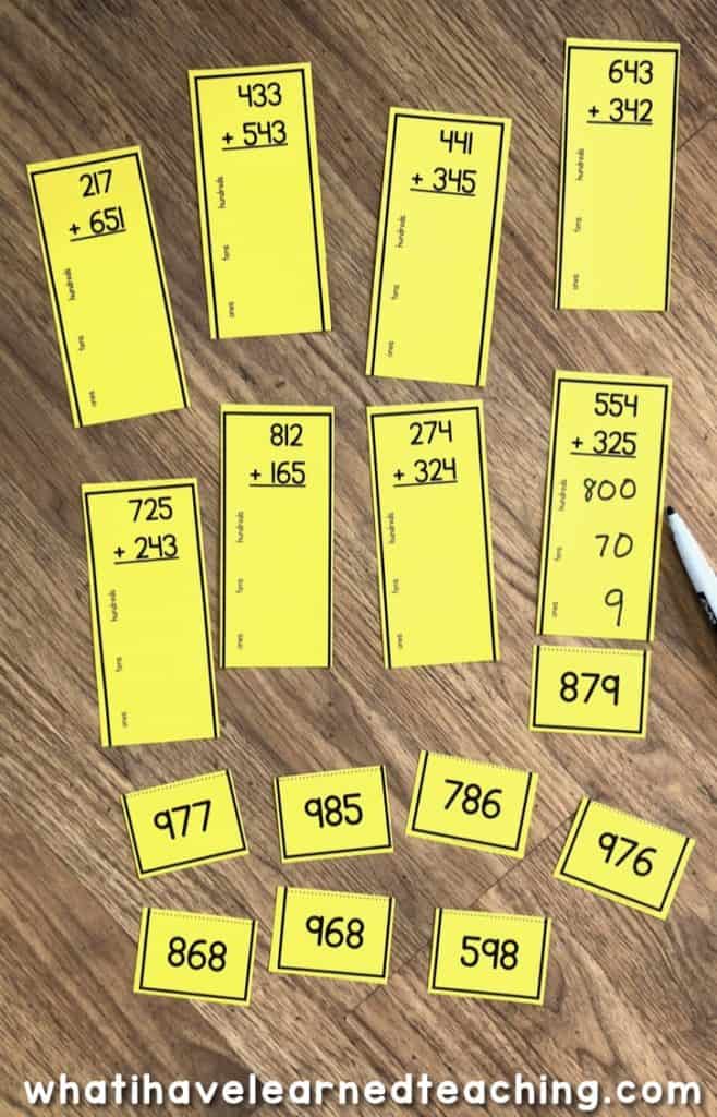 These three-digit addition math centers or task cards help students practice five different addition strategies: use a number line, use base-10 blocks, break apart the addends, use Vs, and vertical addition. The scaffolded levels provide plenty of practice and steps for students to be successful when adding three-digit numbers using a variety of addition strategies. #threedigitaddition #mathcenters #mathstations #secondgrademath