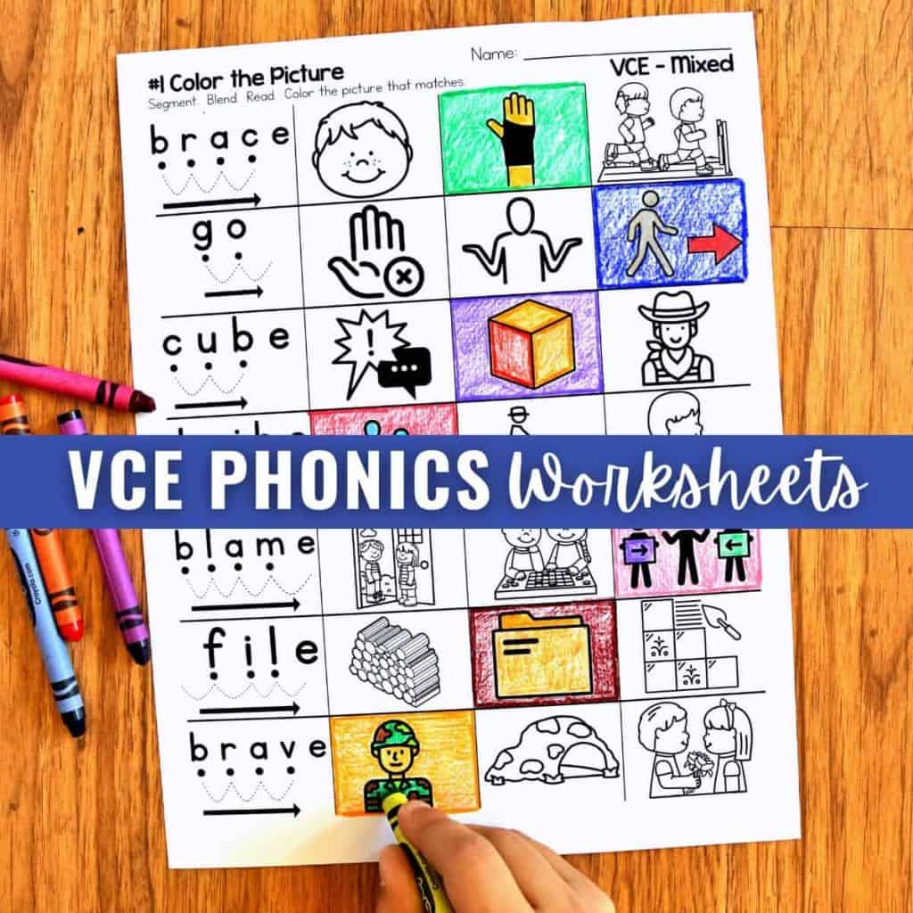 VCE Phonics Worksheets - Silent E Worksheets 8 A VCE Phonics Worksheets page sits on a wooden table, featuring images and words—some pictures colored in. Three crayons (red, blue, purple) and a child’s hand with a yellow crayon are seen. Text reads VCE PHONICS Worksheets.