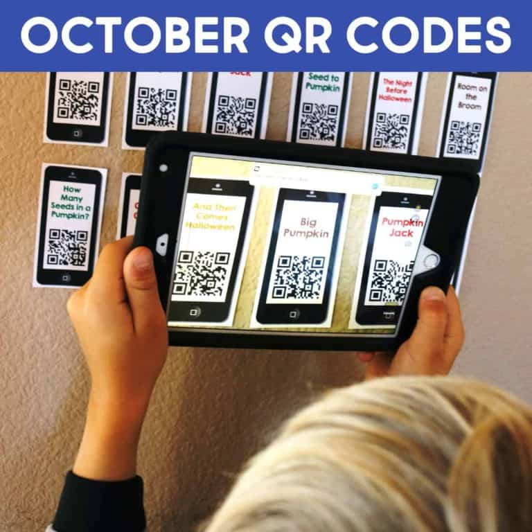 A child scans a halloween qr code on printed cards labeled with Halloween stories for kids using a tablet. The cards are arranged in rows on a wall beneath a banner reading October QR Codes.