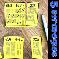 Yellow math cards on a wooden table show subtraction problems and visual aids with base ten blocks. A dry-erase marker is nearby. Text on the right reads 5 strategies in bold blue and white letters.
