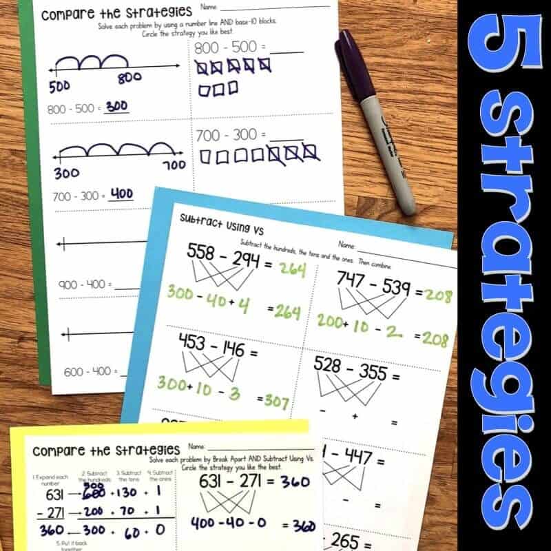 Three-Digit Subtraction.001-min Four worksheets showing different subtraction strategies with numbers, equations, diagrams, and number lines are spread on a wooden surface with a purple marker nearby. The text 5 strategies is on the right in bold blue letters.