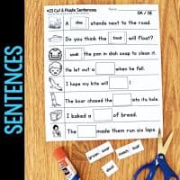 A Long Vowel Teams AI & AY Worksheets & Activities No-Prep Phonics Worksheet with fill-in-the-blank sentences, word options (soar, loaf, coach, soak), pictures, and a glue stick sits on the table next to a blue pencil.