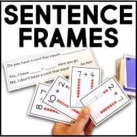 A hand holds several Addition Go Fish Game cards showing addition problems with dot visuals, while sentence frames for practicing questions and answers are displayed above a stack of cards. Text reads: SENTENCE FRAMES.