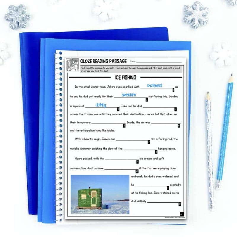 Cloze Reading January Cover.006 The January Cloze Reading Passages for Vocabulary, Syntax and Comprehension product is shown with an Ice Fishing worksheet resting on blue folders beside two pencils and three snowflake decorations, featuring a cloze passage and a green ice fishing hut photo.