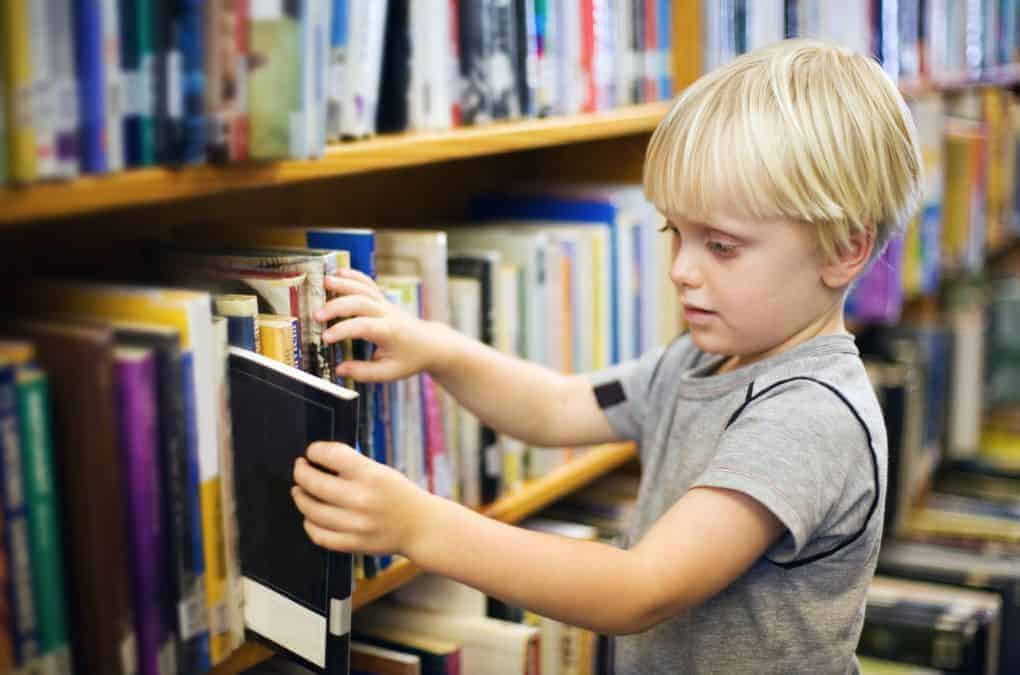 boy choosing a book.