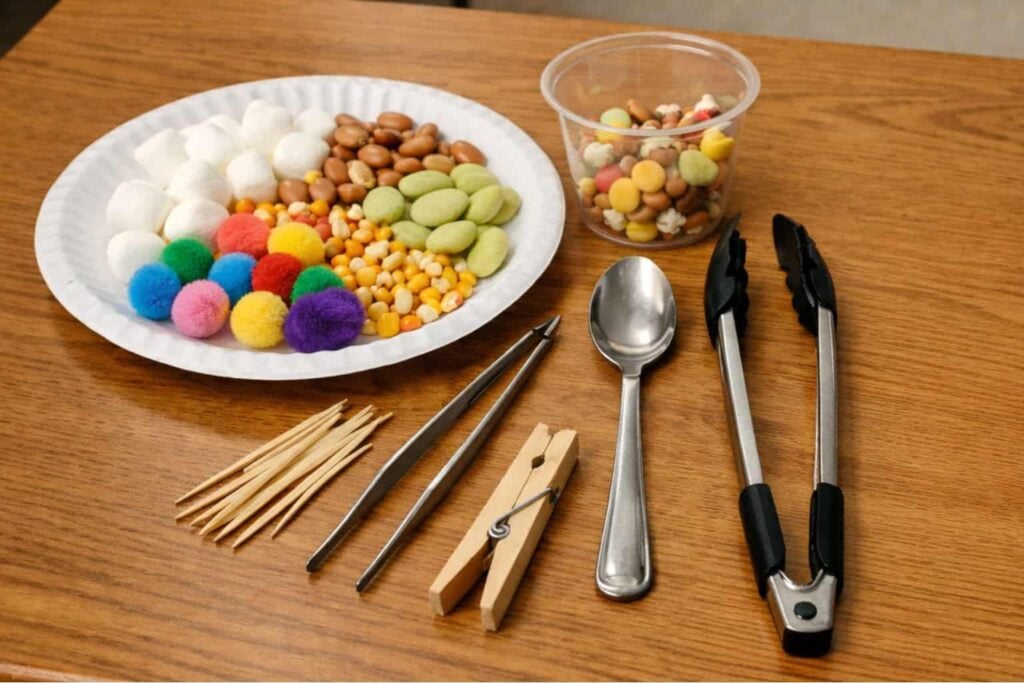 Bird Beak Adaptations: Hands-On Bird Beak Experiment for Students 2 The Bird Beaks lesson ets kids explore bird beak adaptations using tools like tweezers, tongs, and a spoon to pick up different objects, such as cotton balls, pom-poms, beans, corn, and pasta on a paper plate.